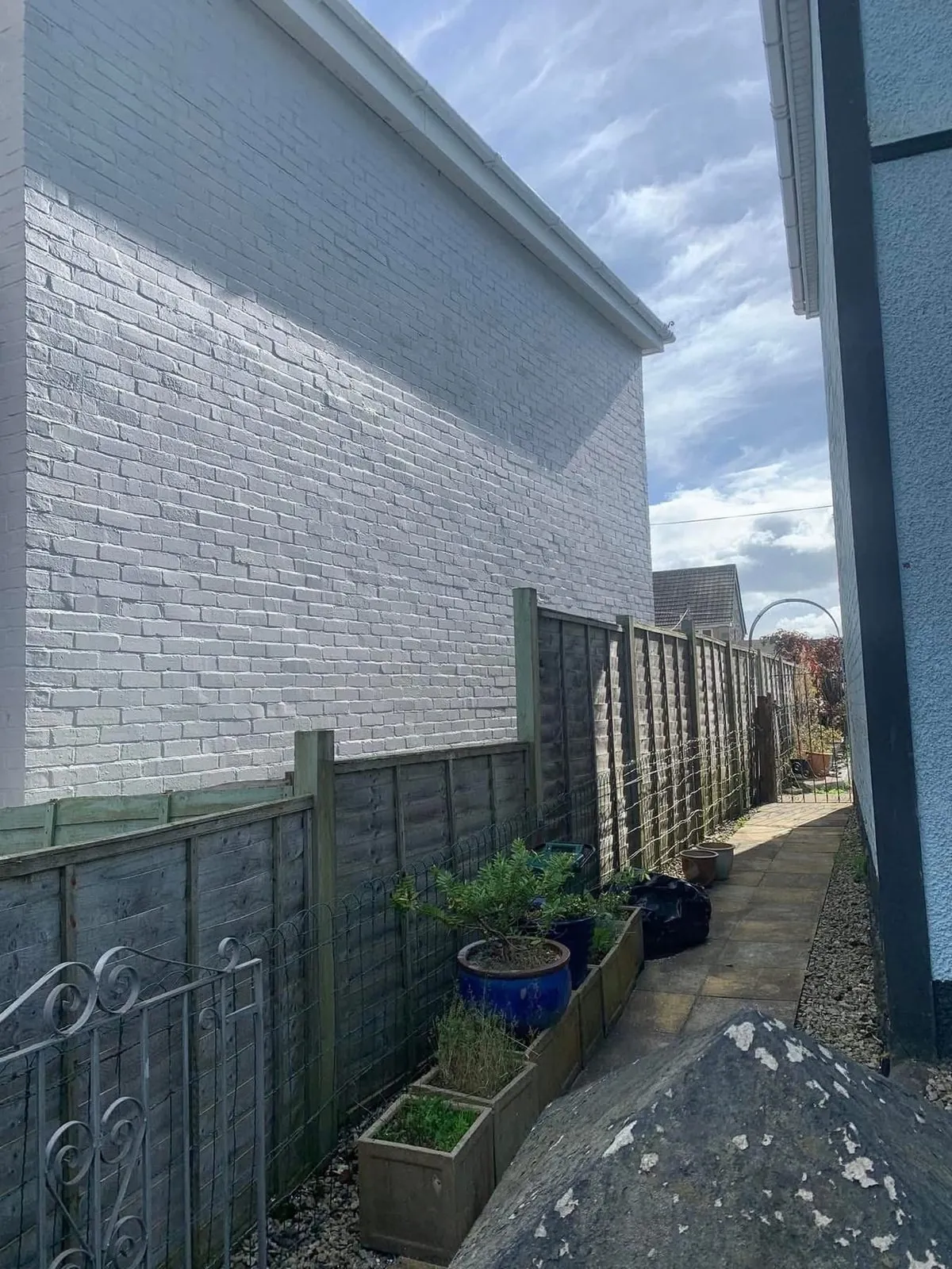 Freshly painted brick wall after preparation and masonry paint in Gorran Haven