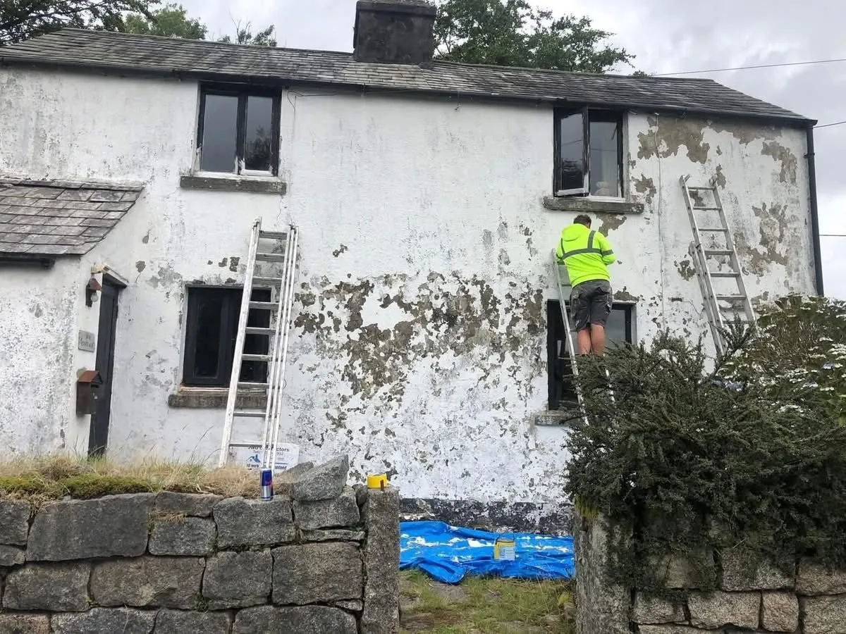 Cottage with blown, flaking render before repair in Gorran Haven